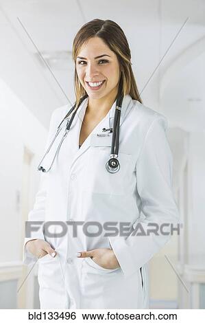 Mixed race doctor smiling in hospital View Large Photo Image Stock Photograph - Mixed race doctor smiling in hospital. Fotosearch