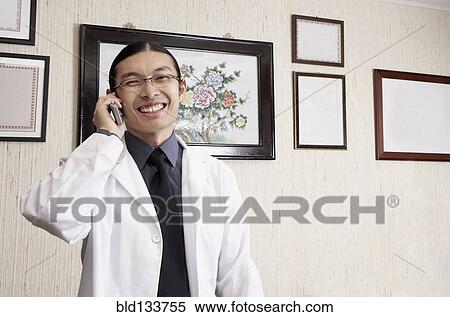 Stock Photography - Mixed race doctor smiling in office. Fotosearch