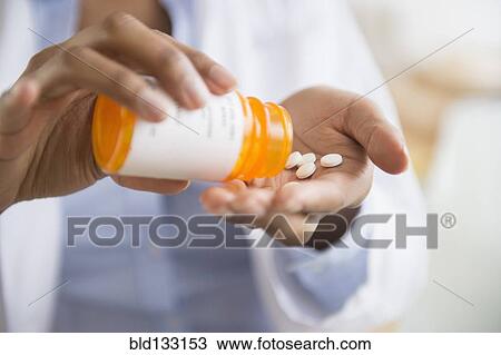 Mixed race doctor taking medication View Large Photo Image Stock Image - Mixed race doctor taking medication. Fotosearch