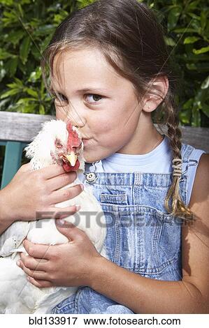 Mixed race girl kissing chicken on farm View Large Photo Image Stock Photo - Mixed race girl kissing chicken on farm. Fotosearch