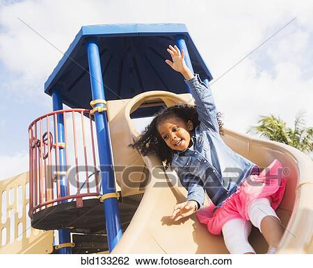 Mixed race girl playing on playground View Large Photo Image Stock Image - Mixed race girl playing on playground. Fotosearch