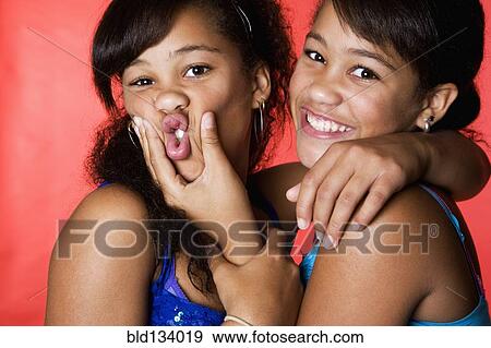 Mixed race teenage twin girls making faces View Large Photo Image Stock Photo - Mixed race teenage twin girls making faces. Fotosearch