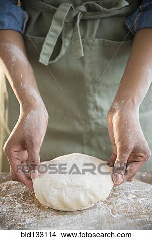 Mixed race woman kneading dough View Large Photo Image Picture - Mixed race woman kneading dough. Fotosearch