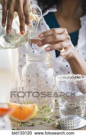 Mixed race woman making cocktail View Large Photo Image Stock Image - Mixed race woman making cocktail. Fotosearch