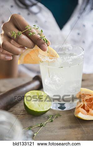 Mixed race woman making cocktail View Large Photo Image Stock Image - Mixed race woman making cocktail. Fotosearch