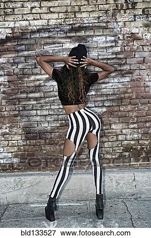 Stock Photo - Mixed race woman posing on city street. Fotosearch