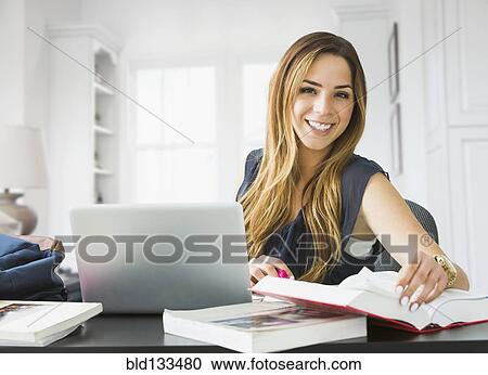 Mixed race woman studying at home View Large Photo Image Stock Image - Mixed race woman studying at home. Fotosearch