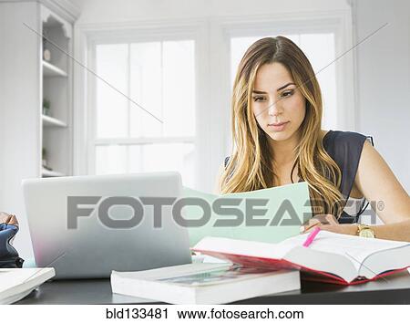 Mixed race woman studying at home View Large Photo Image Stock Image - Mixed race woman studying at home. Fotosearch