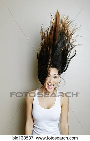 Mixed race woman tossing her hair View Large Photo Image Stock Photo - Mixed race woman tossing her hair. Fotosearch