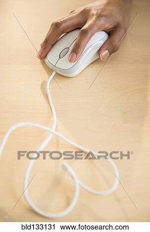 Stock Image - Mixed race woman using computer mouse. Fotosearch