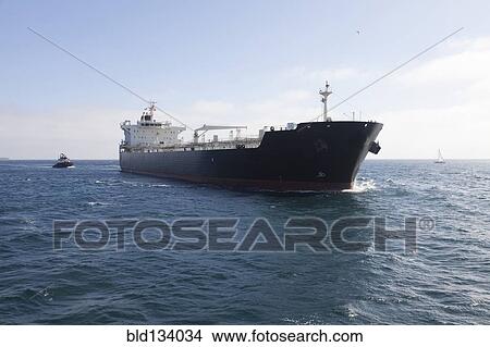 Oil tanker with tugboat at sea View Large Photo Image Picture - Oil tanker with tugboat at sea. Fotosearch