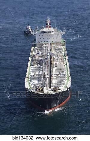 Oil tanker with tugboat at sea View Large Photo Image Stock Image - Oil tanker with tugboat at sea. Fotosearch