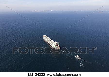 Stock Image - Oil tanker with tugboat at sea. Fotosearch