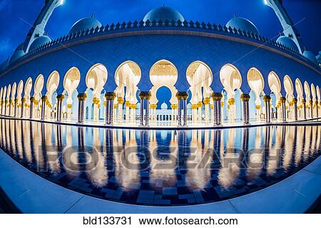 Stock Image - Ornate tiled arches of Grand Mosque, Abu Dhabi, United Arab Emirates. Fotosearch