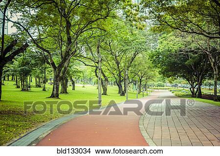 Picture - Paved path in urban park, Kuala Lumpur, Federal Territory of Kuala Lumpur, Malaysia. Fotosearch