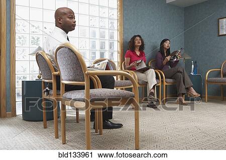 Stock Image - People sitting in dental office waiting room. Fotosearch
