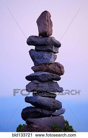 Stock Image - Rocks stacked neatly in rural landscape. Fotosearch