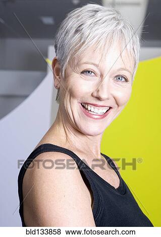 Senior woman smiling in gym View Large Photo Image Stock Photo - Senior woman smiling in gym. Fotosearch