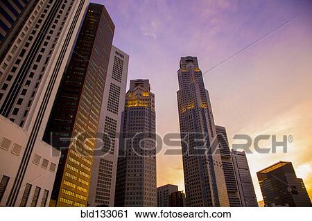 Stock Image - Singapore city skyline and sunset sky, Singapore, Republic of Singapore. Fotosearch