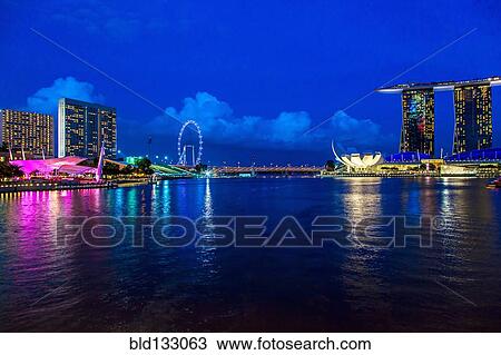 Stock Image - Singapore city skyline lit up at night, Singapore, Republic of Singapore. Fotosearch