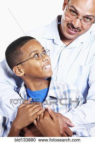 Smiling father hugging son View Large Photo Image Stock Image - Smiling father hugging son. Fotosearch