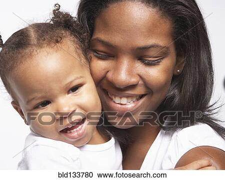 Smiling mother cradling baby View Large Photo Image Stock Image - Smiling mother cradling baby. Fotosearch