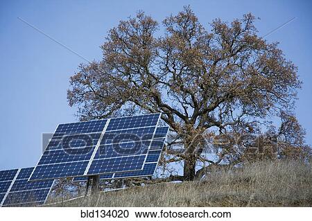 Stock Image - Solar panels on rural hillside. Fotosearch