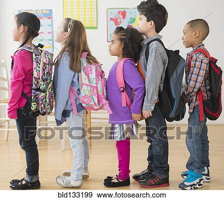 Stock Photo - Students standing in line in classroom. Fotosearch