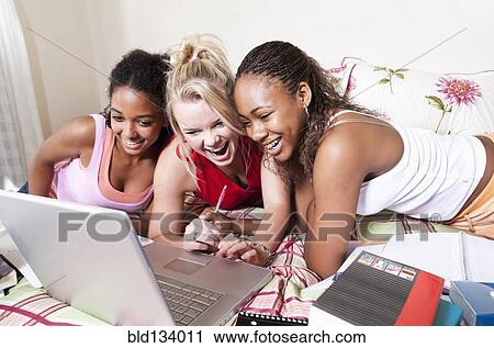 Teenage girls using laptop together View Large Photo Image Stock Image - Teenage girls using laptop together. Fotosearch