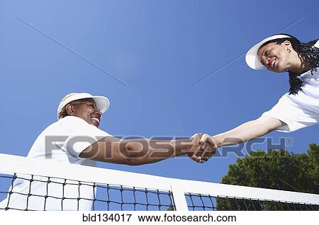 Tennis players shaking hands at net View Large Photo Image Stock Photo - Tennis players shaking hands at net. Fotosearch