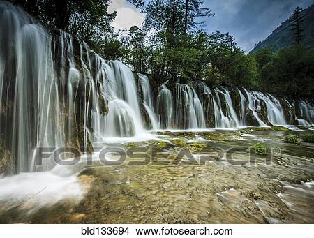 Picture - Waterfall in rural landscape. Fotosearch