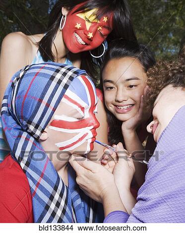 Picture - Woman painting Chinese and United Kingdom flags on children's faces. Fotosearch
