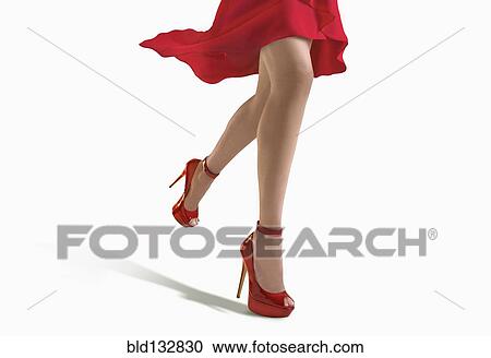 Stock Image - Woman wearing red dress and heels. Fotosearch