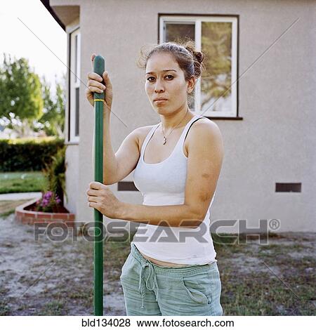 Stock Photo - Woman working in yard. Fotosearch