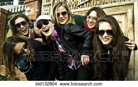 Picture - Women laughing together on city street. Fotosearch