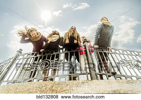 Women leaning over banister View Large Photo Image Stock Photo - Women leaning over banister. Fotosearch