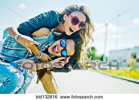 Women playing on city street View Large Photo Image Stock Photograph - Women playing on city street. Fotosearch