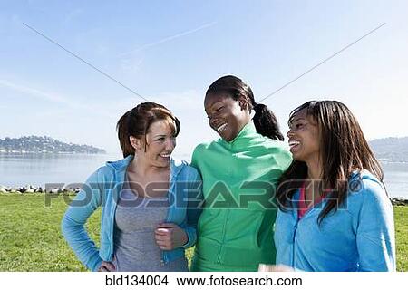 Women smiling by rural lake View Large Photo Image Picture - Women smiling by rural lake. Fotosearch