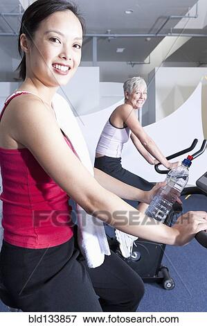 Women using exercise machines in gym View Large Photo Image Stock Photo - Women using exercise machines in gym. Fotosearch