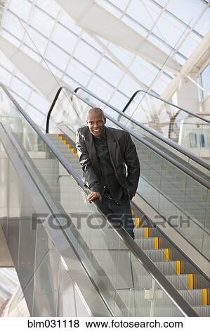 African American businessman smiling on escalator View Large Photo Image Stock Photo - African American businessman smiling on escalator. Fotosearch