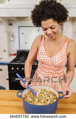 African American woman cooking in kitchen View Large Photo Image Stock Image - African American woman cooking in kitchen. Fotosearch