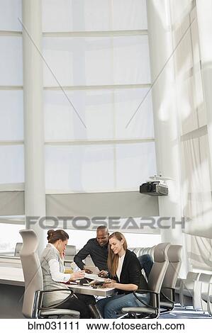 Stock Image - Business people in meeting. Fotosearch