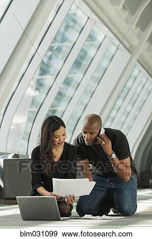 Stock Photo - Business people working on lobby floor. Fotosearch