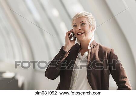 Stock Image - Caucasian businesswoman talking on cell phone. Fotosearch