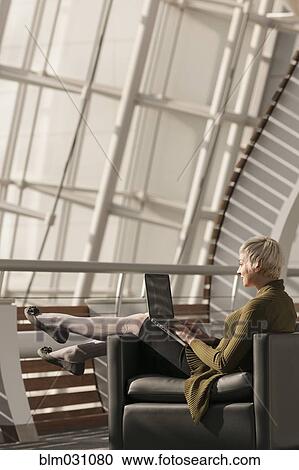 Caucasian businesswoman using laptop in lobby View Large Photo Image Stock Image - Caucasian businesswoman using laptop in lobby. Fotosearch