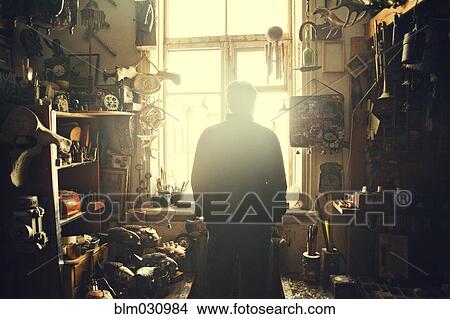 Picture - Caucasian man standing in workshop. Fotosearch