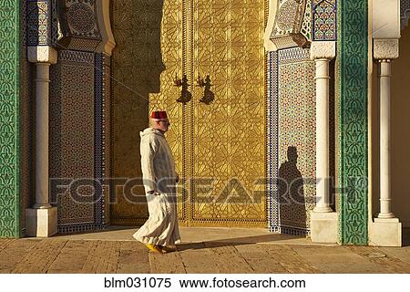 Caucasian man walking by ornate temple View Large Photo Image Stock Photography - Caucasian man walking by ornate temple. Fotosearch