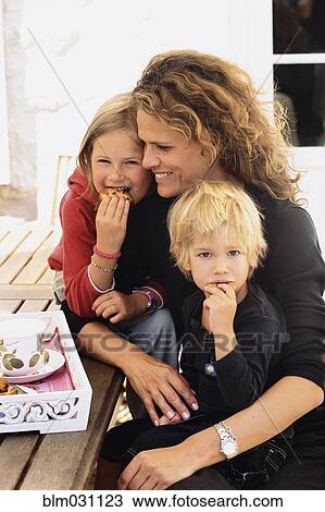 Caucasian mother and children eating outdoors View Large Photo Image Stock Image - Caucasian mother and children eating outdoors. Fotosearch