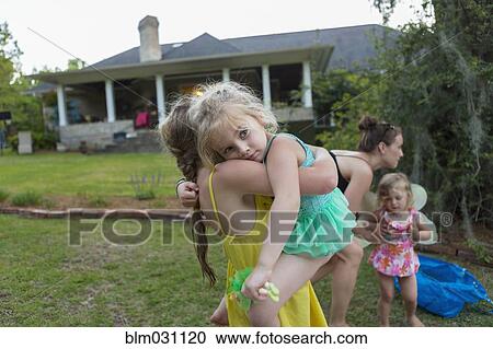 Girl carrying sister outdoors View Large Photo Image Stock Image - Girl carrying sister outdoors. Fotosearch