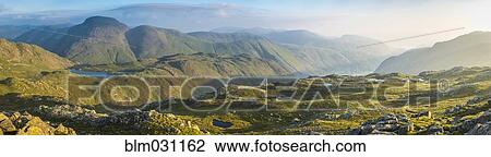 Stock Image - Rolling green hills in rural landscape, Keswick, Cumbria, United Kingdom. Fotosearch